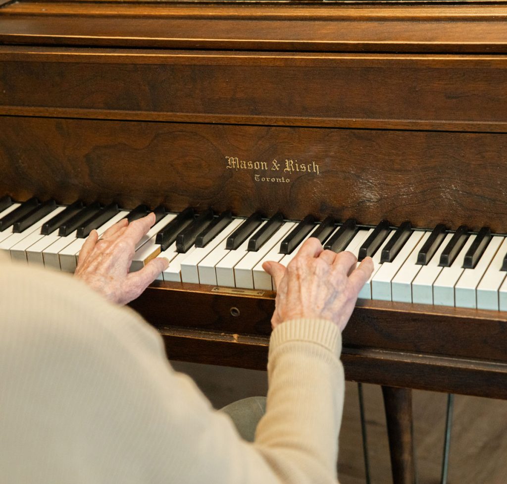 resident sitting playing piano