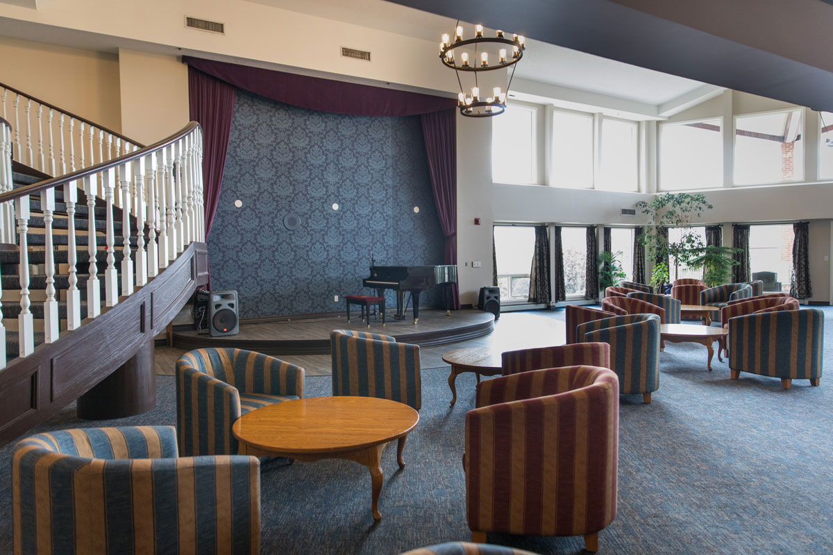 stage area with piano and seating